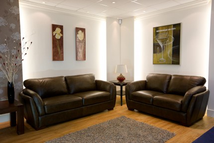 Room set up with brown leather sofas