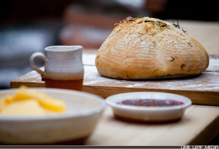 Bread on table in front of jam and butter