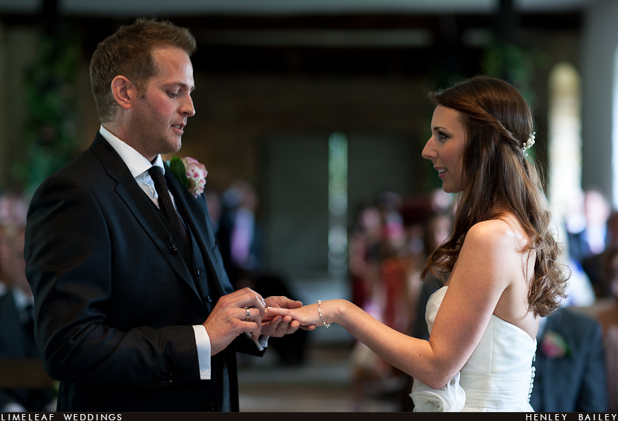 brympton-house-wedding-photography-120728-154627 Groom put wedding ring on his brides finger during their wedding vows