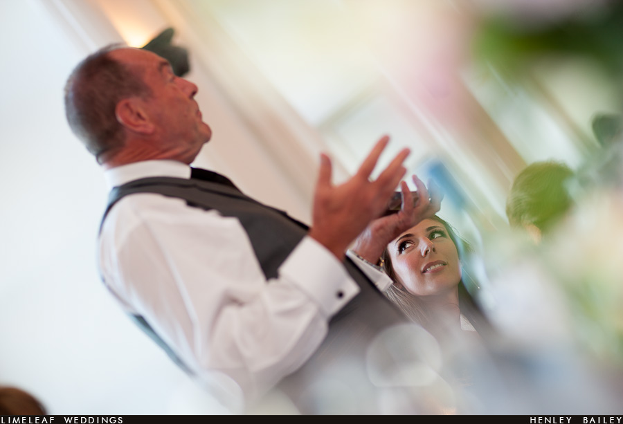 brympton-house-wedding-photography-120728-201526,_ Bride looks on as her father does his wedding speech