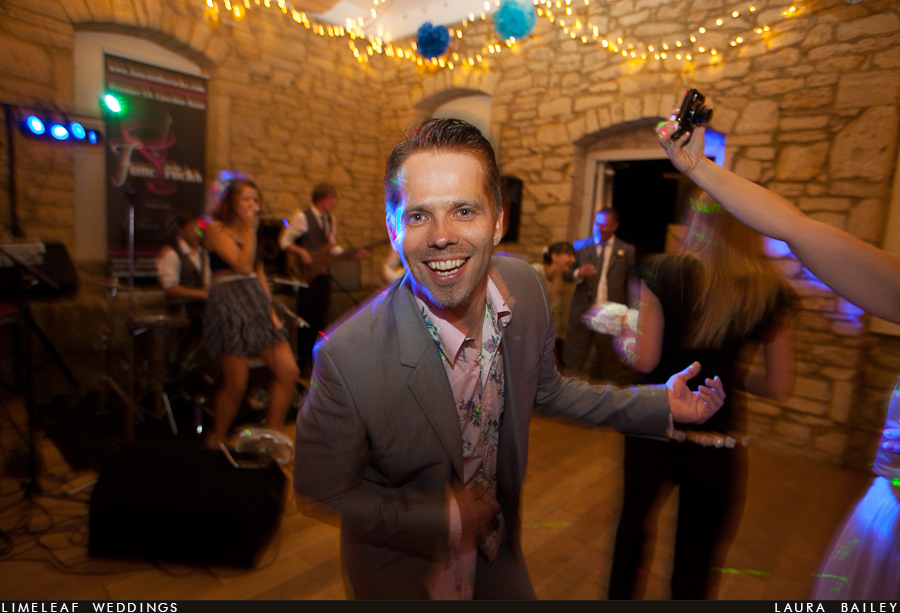 brympton-house-wedding-photography-120728-225604,_ Wedding guest plays air guitar