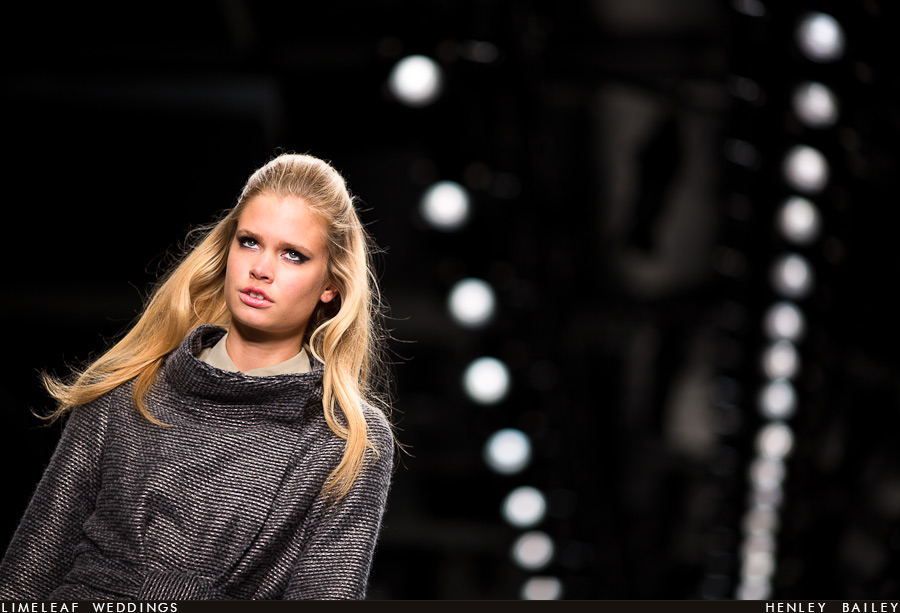 A model in a grey tweed coat on the catwalk at Fashion week