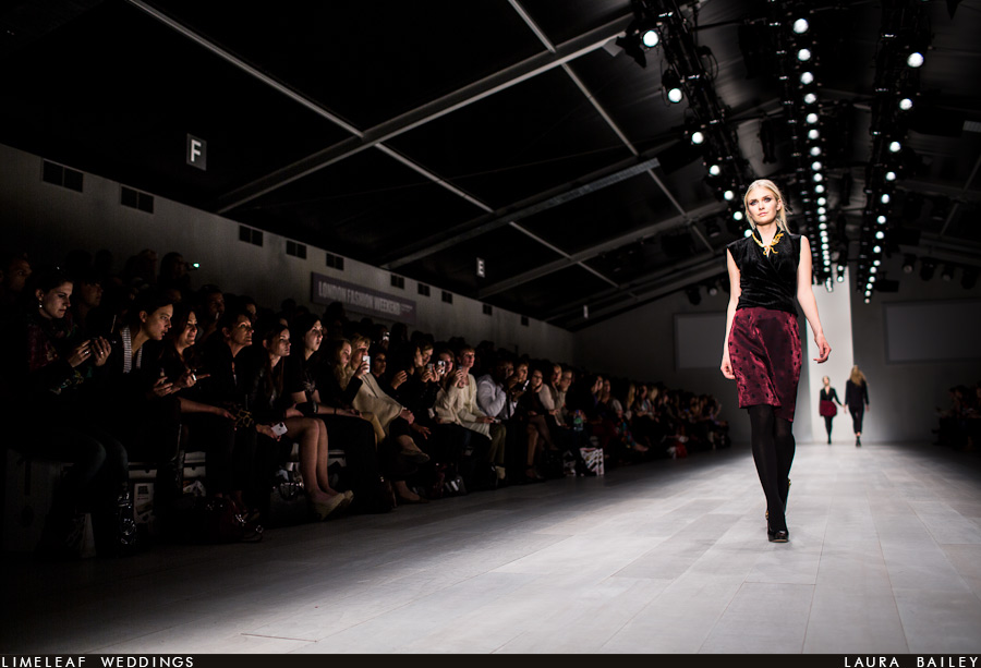 Model heads dows the catwalk as the audience members look on