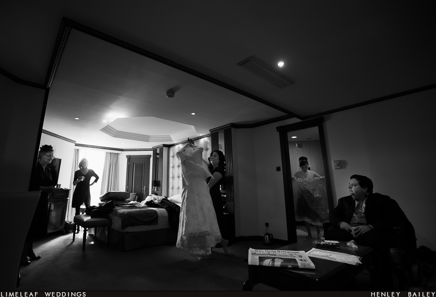 Brides gown carried across Melia White House Hotel room in Regents Park