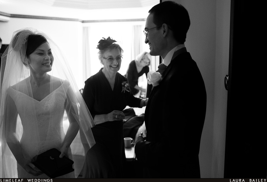 Bride and groom laugh with grooms mother
