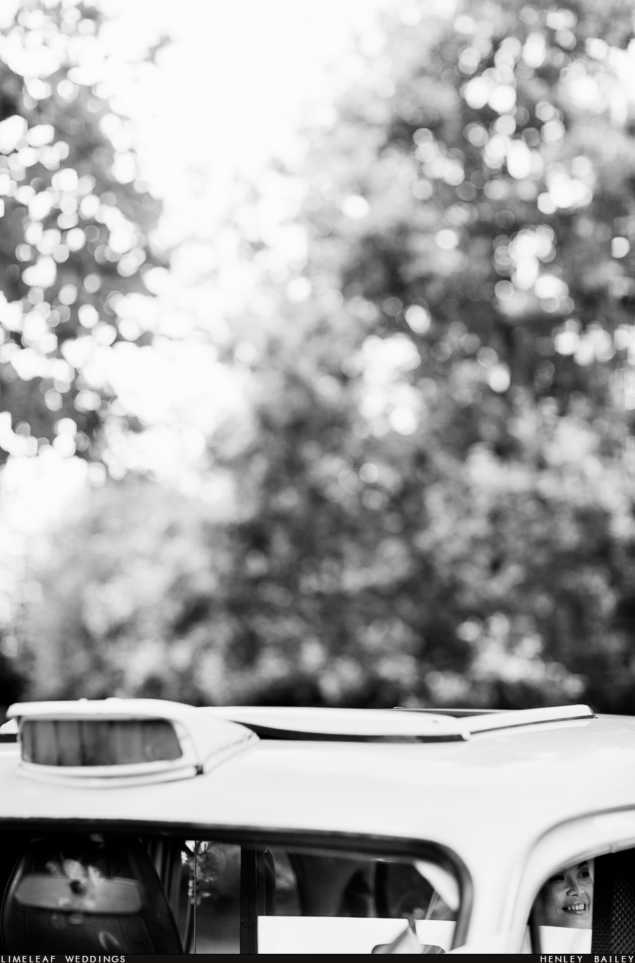 Bride smiling in London taxi cab