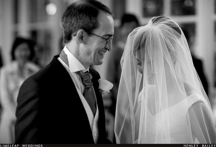 Ashley and Alan smile during their wedding ceremony