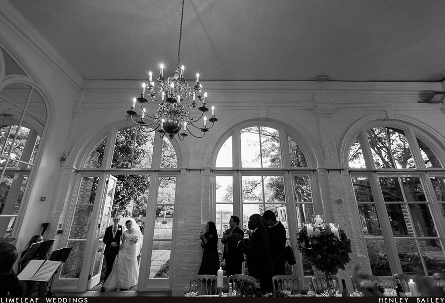 Ashley and Alan enter the orangery for their wedding breakfast