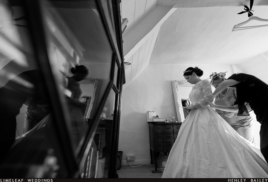 Ilminster bride looks at her engagement ring and is reflected in a cabinet as she does so before her wedding