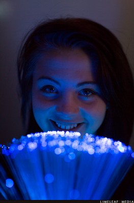 Girl looking over fibre optic lamp