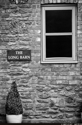 The Long Barn with bush and window