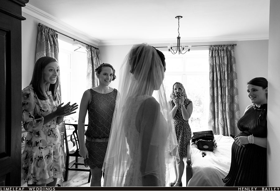 Bridal party admire bride